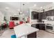 Bright kitchen with white countertop island, stainless steel appliances, and view to living area at 11123 E Olla Ave, Mesa, AZ 85212