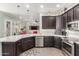 Kitchen with stainless steel appliances, dark cabinetry, and white countertop island at 11123 E Olla Ave, Mesa, AZ 85212