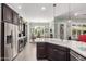 Well-lit kitchen with stainless steel appliances, wine cooler, quartz countertops, and eat-in dining area at 11123 E Olla Ave, Mesa, AZ 85212