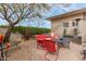 Charming patio area with red seating, perfect for enjoying the serene outdoor space at 11123 E Olla Ave, Mesa, AZ 85212