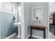 Stylish powder room with pedestal sink, decorative mirror, and natural light at 11123 E Olla Ave, Mesa, AZ 85212
