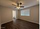 This bedroom features a ceiling fan, wood-look floors, and a window for plenty of natural light at 11189 W Cameo Dr, Sun City, AZ 85351