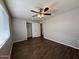 This bedroom features a ceiling fan, wood-look floors, closet and a window for natural light at 11189 W Cameo Dr, Sun City, AZ 85351