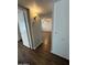 Hallway with wood-look floors and a view of the living room through a doorway at 11189 W Cameo Dr, Sun City, AZ 85351