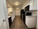 Functional kitchen showcasing updated countertops, black appliances, and a convenient layout at 11189 W Cameo Dr, Sun City, AZ 85351