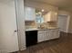 Kitchen featuring sleek black appliances, granite counters, and modern fixtures at 11189 W Cameo Dr, Sun City, AZ 85351