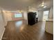 Open-concept living and kitchen area with a modern feel, wood-look flooring, and black appliances at 11189 W Cameo Dr, Sun City, AZ 85351