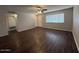 Spacious living room featuring wood-look flooring, neutral walls and a ceiling fan for a move-in ready space at 11189 W Cameo Dr, Sun City, AZ 85351