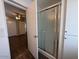 The shower features a sliding glass door, a shower head, and a white surround at 11189 W Cameo Dr, Sun City, AZ 85351