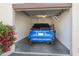 Garage with a blue car parked inside, and red flowers to the left side at 11260 N 92Nd St # 1060, Scottsdale, AZ 85260