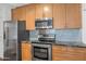 Updated kitchen featuring stainless steel appliances, light wood cabinetry, and granite countertops at 11260 N 92Nd St # 1060, Scottsdale, AZ 85260