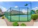 Outdoor tennis court featuring green fencing and walkways at 11260 N 92Nd St # 1060, Scottsdale, AZ 85260