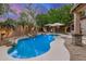 Backyard pool featuring rock features and a seating area with umbrellas at 1252 N Pine St, Gilbert, AZ 85233