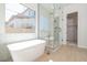 The bathroom features a luxurious soaking tub and frameless glass shower, creating a spa-like retreat at 1254 E Penedes Dr, Gilbert, AZ 85298