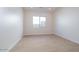 Bedroom with window, neutral walls and light wood look floors at 1254 E Penedes Dr, Gilbert, AZ 85298