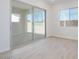 Bright, neutral bedroom with a large sliding glass door and light wood floors at 1254 E Penedes Dr, Gilbert, AZ 85298