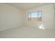 Bright bedroom features a large window and neutral carpeting, offering a serene and comfortable living space at 1254 E Penedes Dr, Gilbert, AZ 85298