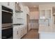 Bright kitchen featuring white cabinets, stainless steel appliances, and gold fixtures at 1254 E Penedes Dr, Gilbert, AZ 85298