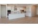 Bright, spacious kitchen featuring white cabinets, stainless steel appliances, and island at 1254 E Penedes Dr, Gilbert, AZ 85298