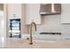 Bright kitchen featuring white cabinets, stainless steel appliances, and gold fixtures at 1254 E Penedes Dr, Gilbert, AZ 85298