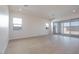 Bright living room with light wood floors and sliding glass doors leading to the backyard at 1254 E Penedes Dr, Gilbert, AZ 85298