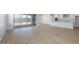 Bright living room with access to kitchen, large sliding glass door and light wood floors at 1254 E Penedes Dr, Gilbert, AZ 85298
