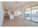 Bright living room with access to kitchen, large sliding glass door and light wood floors at 1254 E Penedes Dr, Gilbert, AZ 85298