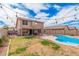 Home's backyard boasts a sparkling pool, patio, and green space, creating a serene outdoor retreat at 12574 W Desert Rose Rd, Avondale, AZ 85392