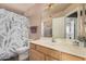 Bathroom featuring shower with patterned curtain, toilet and sink at 12574 W Desert Rose Rd, Avondale, AZ 85392