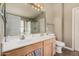 Bathroom featuring double sinks, a large mirror, and a separate shower and toilet area at 12574 W Desert Rose Rd, Avondale, AZ 85392