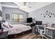 Bedroom featuring a cozy bed, desk area, ceiling fan, and a bright window at 12574 W Desert Rose Rd, Avondale, AZ 85392