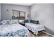 Bedroom featuring two beds, wood-look floors, and a window at 12574 W Desert Rose Rd, Avondale, AZ 85392