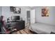Bedroom showing gray walls, wood-look floors, desk and a view of the hallway at 12574 W Desert Rose Rd, Avondale, AZ 85392