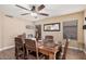 Dining room with a wood table, leather chairs, tile floors, and stylish ceiling fan at 12574 W Desert Rose Rd, Avondale, AZ 85392