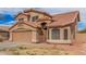 Two-story stucco home with a tile roof, attached two-car garage, and covered entryway at 12574 W Desert Rose Rd, Avondale, AZ 85392