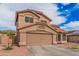 Two-story stucco home with a tile roof, attached two-car garage and tidy desert landscaping at 12574 W Desert Rose Rd, Avondale, AZ 85392