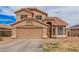 Two-story home with a tile roof, two-car garage, desert landscaping and an arched entryway at 12574 W Desert Rose Rd, Avondale, AZ 85392