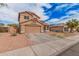 Two-story stucco home with a tile roof, two-car garage, desert landscaping, and driveway at 12574 W Desert Rose Rd, Avondale, AZ 85392
