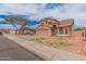 Two-story home with a tile roof, two-car garage, desert landscaping and mature trees at 12574 W Desert Rose Rd, Avondale, AZ 85392