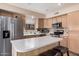 The bright kitchen features stainless steel appliances and ample counter space for all of your cooking needs at 12574 W Desert Rose Rd, Avondale, AZ 85392