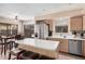 Bright kitchen boasts stainless steel appliances and a central island with bar seating, perfect for casual dining at 12574 W Desert Rose Rd, Avondale, AZ 85392