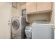 Laundry room featuring stainless steel washer and dryer at 12574 W Desert Rose Rd, Avondale, AZ 85392