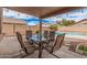 Outdoor patio with dining set overlooking a private pool and backyard, perfect for entertaining and relaxing at 12574 W Desert Rose Rd, Avondale, AZ 85392