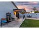 Inviting backyard with covered patio, artificial grass, and desert landscaping perfect for outdoor enjoyment at 12630 W Aster Dr, El Mirage, AZ 85335
