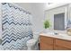 Bright bathroom with white fixtures, and a large mirror at 12630 W Aster Dr, El Mirage, AZ 85335