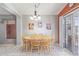 Bright dining room with a wooden table and chairs, complemented by artistic posters and a sliding glass door at 12630 W Aster Dr, El Mirage, AZ 85335