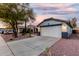 Welcoming single-story home with a two-car garage, easy care landscaping, and a well-maintained driveway at 12630 W Aster Dr, El Mirage, AZ 85335