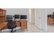 Spacious home office with a large desk, multiple monitors, and ample natural light at 12630 W Aster Dr, El Mirage, AZ 85335