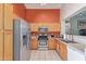 Well-lit kitchen featuring stainless steel appliances, ample counter space, and light wood cabinetry for storage at 12630 W Aster Dr, El Mirage, AZ 85335