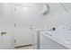 Well-equipped laundry room with modern appliances and storage at 12630 W Aster Dr, El Mirage, AZ 85335